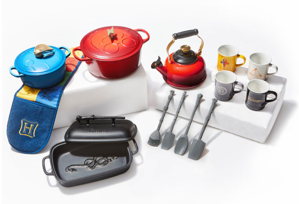 Le Creuset Harry Potter Cookware Collection: two french ovens, kettle, 4 mugs, casserole dish, and four kitchen utensils.